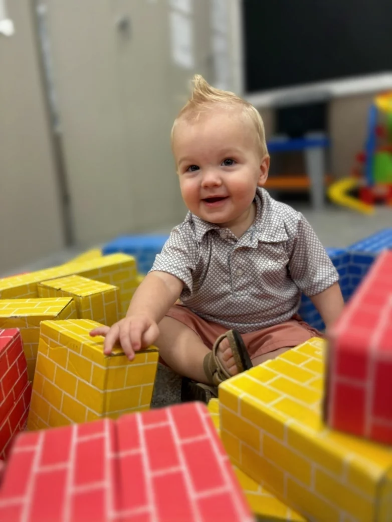 Child building with colorful blocks at our daycare center